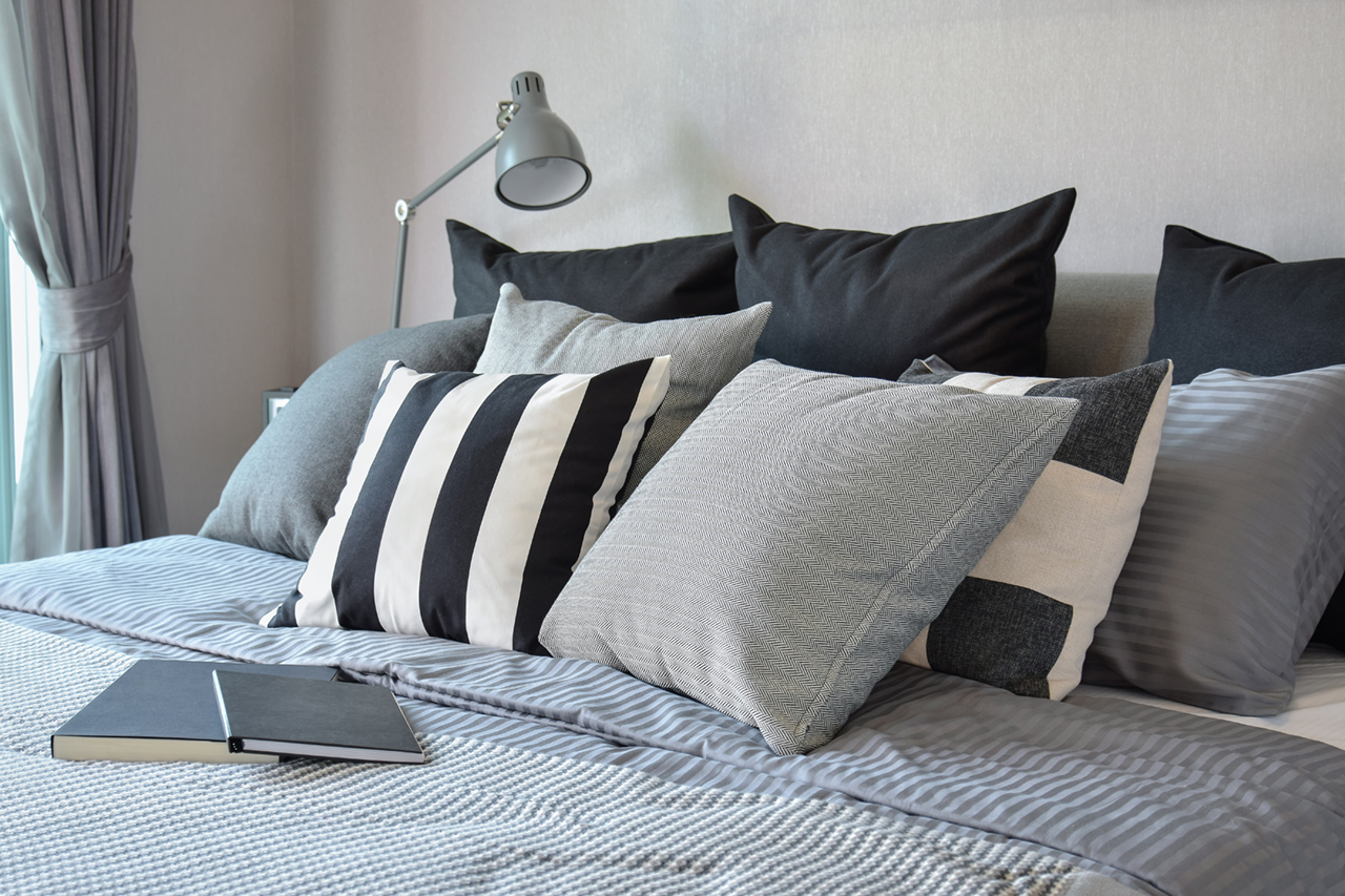 stylish bedroom interior design with black patterned pillows on